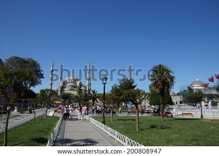ISTANBUL, TURKEY - MAY 15, 2014 -Tourists walk towards  Sultan Ahmet Camii ( Blue Mosque ) in Istanbul, Turkey