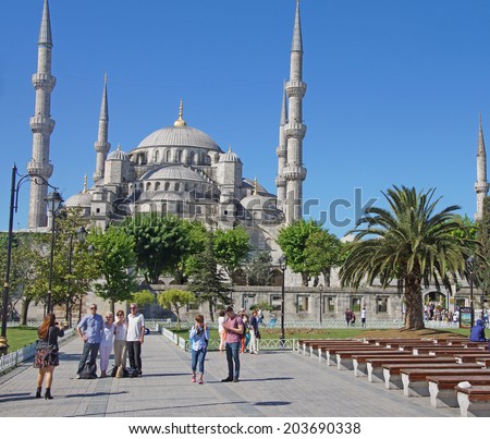 ISTANBUL, TURKEY - MAY 15, 2014 -Tourists walk towards  Sultan Ahmet Camii ( Blue Mosque ) in Istanbul, Turkey