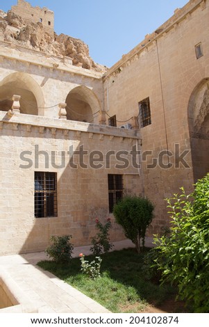 Courtyard of the  Isa Bey Medresseh, made from local light colored stone,  Mardin,  Turkey