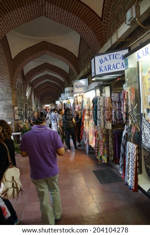 BURSA, TURKEY - MAY 22, 2014 - Women with scarves choosing clothing in the bazaar of  Bursa, Turkey