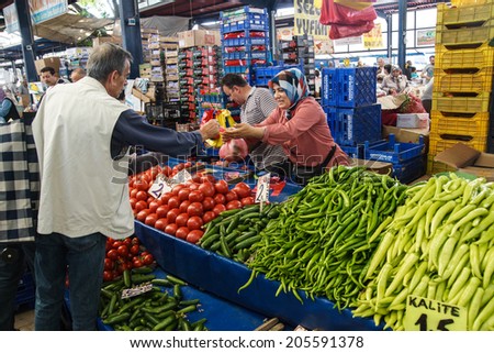 CANAKKALE, TURKEY - MAY 23, 2014 - Local shoppers buy vegetables at the weekly market  in Canakkale,  Turkey