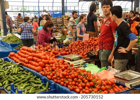 CANAKKALE, TURKEY - MAY 23, 2014 - Shoppers buy tomatoes at the weekly market  in Canakkale,  Turkey