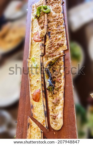 Turkish Pide are served on long planks to hungry tourists  in  Antalya,  Turkey