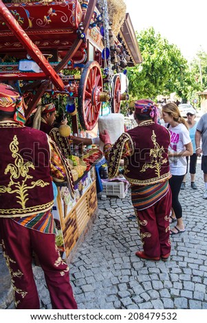 SIRINCE, TURKEY - MAY 25, 2014 - Costumed vendors sell traditional Turkish ice cream in  Ephesus, Turkey