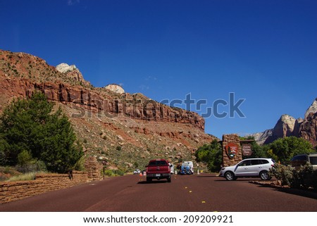 ZION, UTAH - SEP 27, 2013 - Rangers meet tourists at the entrance to Zion National Park, Utah