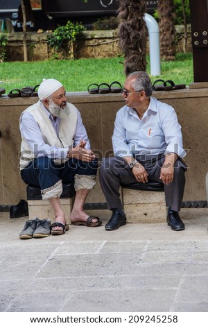 BURSA, TURKEY - MAY 22, 2014 - Older men sit and talk in the afternoon  in the bazaar of  Bursa, Turkey