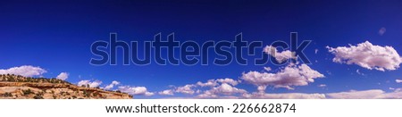 Dramatic clouds and blue sky over desert landscape of Escalante Staircase National Monument, Utah