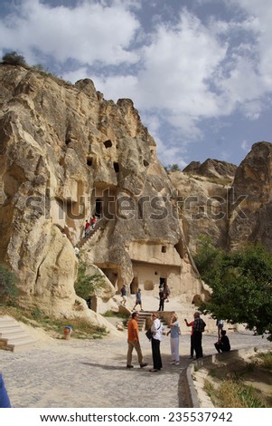 CAPPADOCIA, TURKEY - JUN 4, 2014 - Tourists explore Ancient Christian cave churches Cappadocia in Turkey