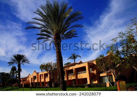 RANCHO MIRAGE, CALIFORNIA - DEC 20, 2014 - Southwestern style hotel buildings in green oasis with Palm trees,  Rancho Mirage, California
