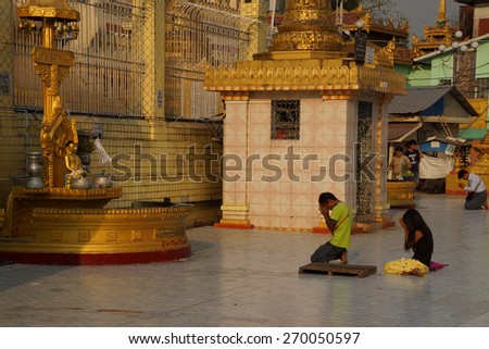 YANGON, MYANMAR - MAR 2, 2015 - Buddhists pray at the planetary post of their birth day,  Botataung Pagoda, Yangon,  Myanmar (Burma)