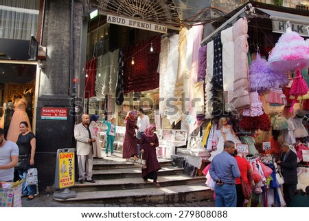 ISTANBUL, TURKEY - MAY 17, 2014 -Locals shop for children\'s clothes in the narrow streets near the Egyptian Bazaar,  in Istanbul, Turkey