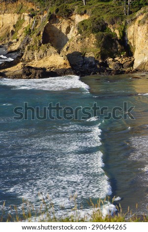 Beach and surf near rocky coast hillsides,  Oregon Coast