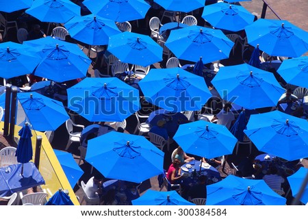 Blue umbrellas of outdoor restaurant, waterfront,  Seattle, Washington