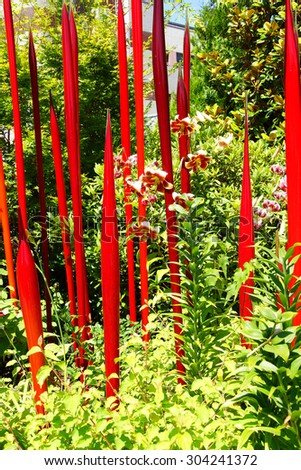 SEATTLE - JUL 23, 2015 - Red blown glass tubes rise among lilies in the  Chihuly Garden and Glass Museum,  Seattle, Washington
