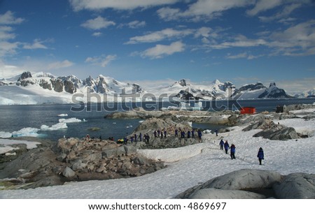 Cruise  tourists moving down to landing station, amid icebergs & glaciers		Petermann Island,	Antarctica