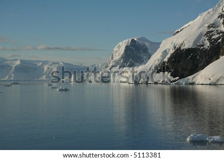 Mountains & glaciers reflected in calm ocean,		Neko Harbor, Andvord Bay,	Antarctica