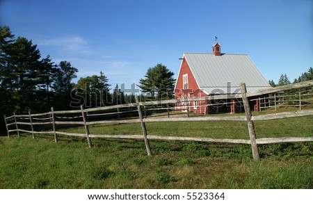 New England red barn and fence against blue sky.			Mount Desert Island, Acadia National park, Maine, New England