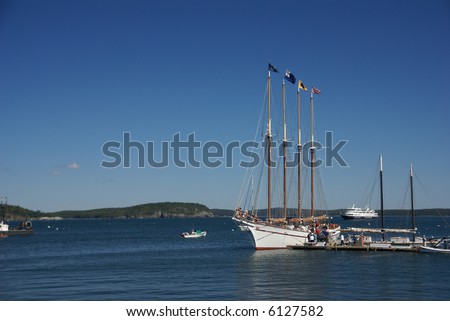 Tall ship in harbor; schooner boarding passengers, with harbor in background. 		Bar Harbor,	Mount Desert Island, Acadia National park, Maine, New England