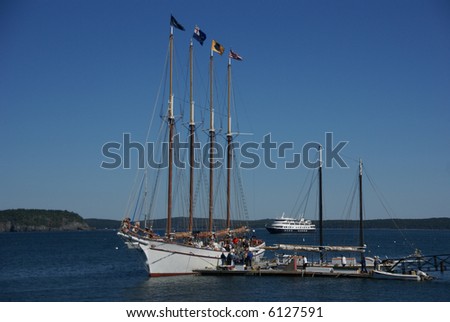 Tall ship in harbor; schooner boarding passengers, with harbor in background. 		Bar Harbor,	Mount Desert Island, Acadia National park, Maine, New England