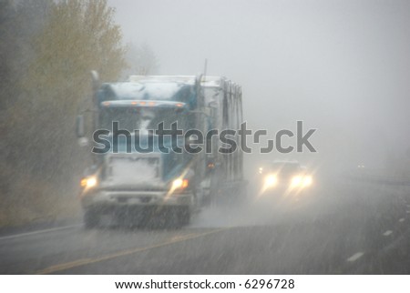 Trucks moving through fog and snowstorm,		Rocky Mountains,	Idaho