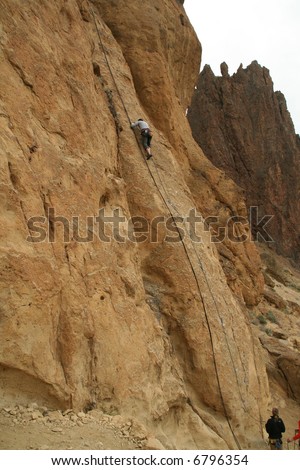 Rock climber on sheer cliff,		Smith Rock State Park, 	Central Oregon