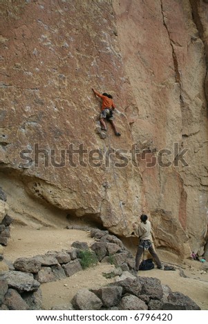 Climber on unprotected face route, with belayer spotting for him. 		Smith Rock State Park, 	Central Oregon