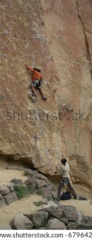 Climber on unprotected face route, with belayer spotting for him. 		Smith Rock State Park, 	Central Oregon