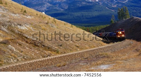 Freight train hauling up the Rocky Mountains,		Columbia Icefield Parkway,	Alberta, Canada