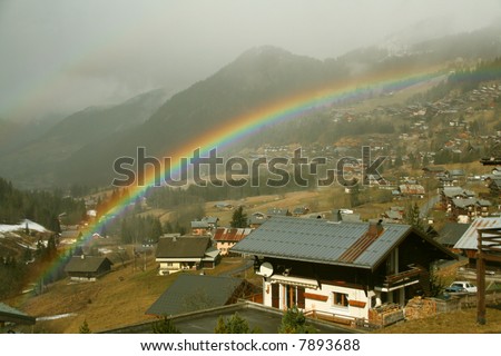 Rainbow across alpine village,		Chatel,French Alps,	France