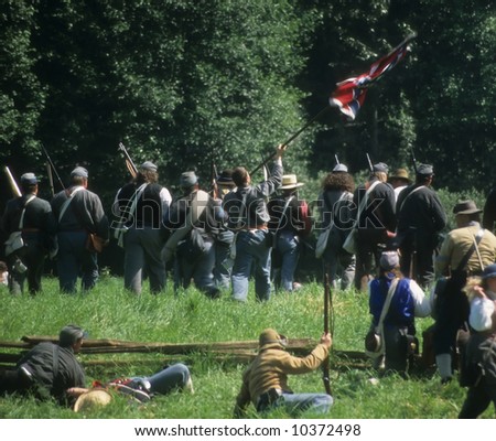 Confederate soldiers advance, 	Civil War battle reenactment