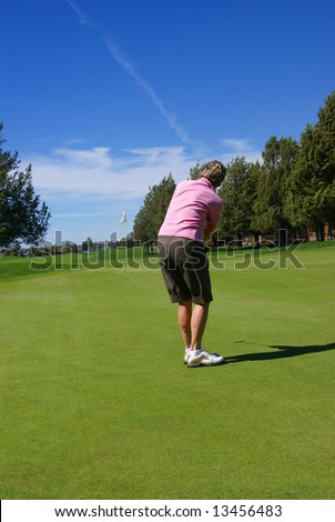 Lady golfer putting on green, Eagle Crest Resort Golf Course,	Central Oregon