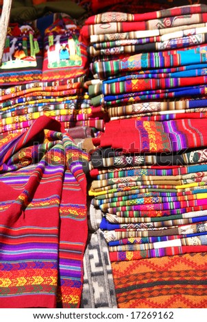 Colorful handmade blankets & tablecloths,	Pisac market, 	Cusco,	Peru, South America