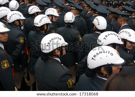 LIMA, PERU - 30 AUG 2008: Unidentified female transit police watching a parade,	on August 30, 2008 in Lima,	Peru, South America