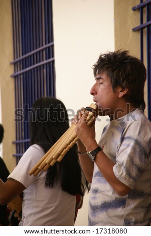 CUSCO, PERU - 29  AUG 2008: Unidentified Man playing pan pipes, Andean music on August 29, 2008 in Cusco,	Peru, South America