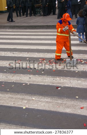 Orange maintenance man, sweeping street after parade,  Lima, Peru, South America