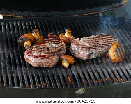 Rib eye steak and mushrooms on the grill,  Seattle, Pacific Northwest