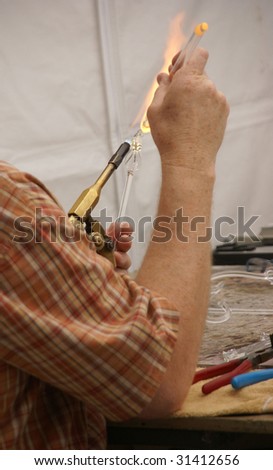 Glass blower doing delicate work over gas burner,   Pacific Northwest