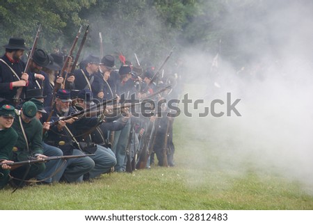 PORT GAMBLE, WA - JUN 20: Civil War reenactors participate in a mock battle. Union infantry line firing a volley.