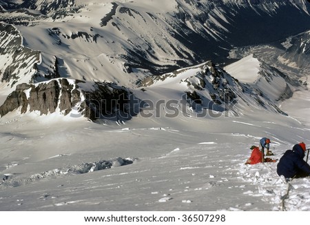 Rope team taking rest stop during descent of 	Emmons Glacier,	Mt Rainer,	Washington