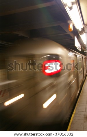 Blur of approaching subway,			New York City