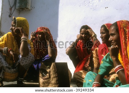 PUSHKAR, INDIA - NOVEMBER 8 : Women in brightly colored scarves and saris gather for a market during the Pushkar Camel Fair November 8, 2003 in Pushkar, India.