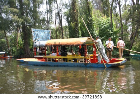 XOCHIMILCO, MEXICO -  SEPTEMBER 3 : Mariachi guitar players entertain guests on drifting barges on canals on September 3, 2008 in Xochimilco, Mexico.