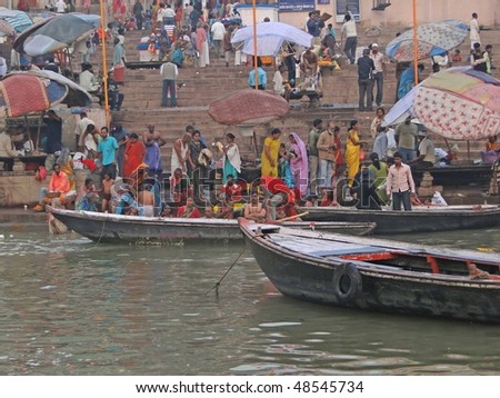 VARANASI, INDIA - NOV 6: Hindus perform ritual puja at dawn in the Ganges River on Nov 6, 2009,  in Varanasi, India.