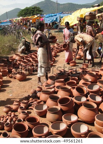 ORISSA, INDIA - NOV 11 - Tribal women buy clay pots on Nov 11, 2009, in Chatikona market, Orissa, India