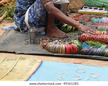 Selling bangles and other jewelry  at the weekly market  in Kunduli, Orissa in India