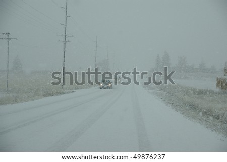 Truck and other vehicles moving through fog and snowstorm,  Rocky Mountains, Idaho