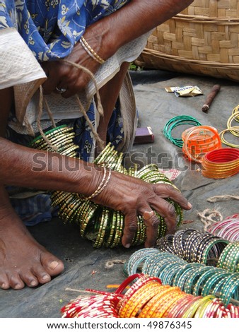 Selling bangles and other jewelry  at the weekly market  in Kunduli, Orissa in India