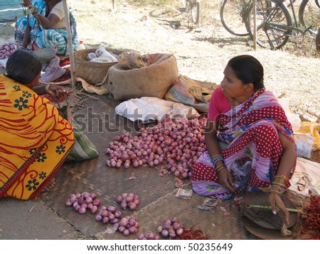ORISSA, INDIA - NOV 11 - Woman selling potatoes  on Nov 11, 2009,  in Chatikona market, Orissa, India