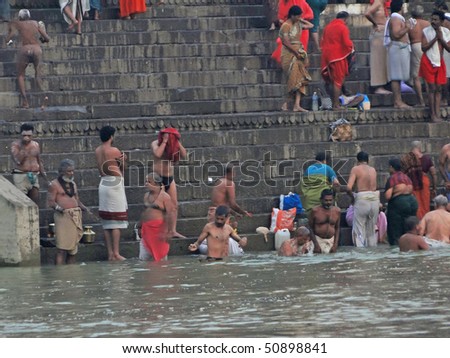 VARANASI, INDIA - NOV 6 -  Hindus perform ritual puja at dawn in the Ganges River  on Nov 6, 2009,  in Varanasi, India.