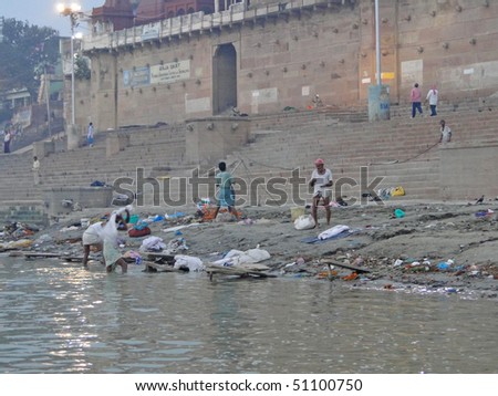 VARANASI, INDIA - NOV 6 -  Dhobiwallahs wash clothes in the Ganges River  on Nov 6, 2009,  in Varanasi, India.